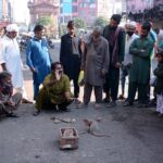 A juggler performing tricks to earn his livelihood at roadside