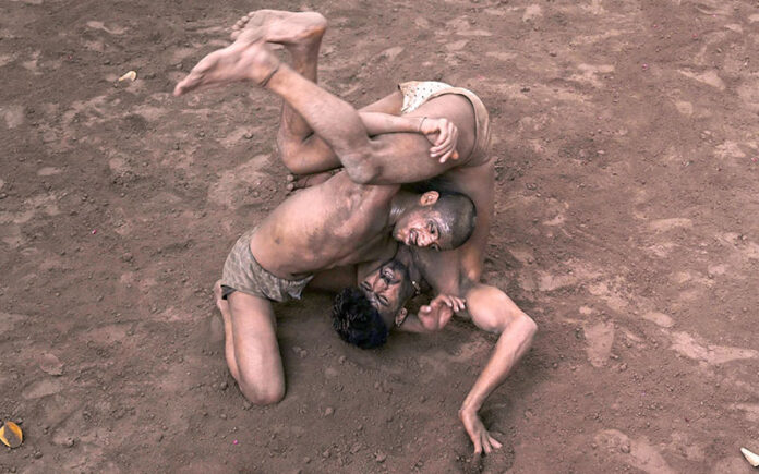 Traditional wrestlers (Pehalwans) are busy in practicing during a training session at an Akhara (wrestling pit).'Kushti', the traditional wrestling is one of the most popular games in Pakistan. Thousands of years ago when there was no cricket, no hockey, no football, the most enjoyable hobby of the people was wrestling. Even today after the introduction of so many kinds of sporting activities around the world, the sport of wrestling draws more crowds than any other sport because, fighting is a part of human nature. There are different styles of wrestling in the world today but the most famous among them is the Freestyle Wrestling