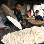 A vendor prepares fresh popcorn for customers at Kohati Chowk in the city