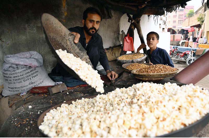 A vendor prepares fresh popcorn for customers at Kohati Chowk in the city