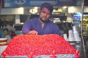 A vendor displaying pomegranate to attract the customers on handcart.