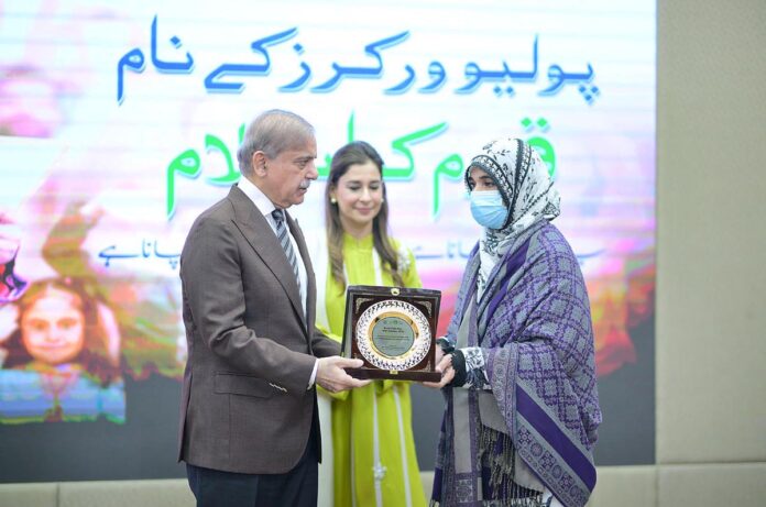 Prime Minister Muhammad Shehbaz Sharif presenting souvenirs to front line Polio Workers and the relatives of those Polio Workers who embraced martyrdom in the line of duty