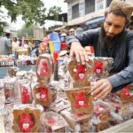 A vendor displaying beautiful decoration pieces on his handcart to attract customers near Mohallah Jhangi