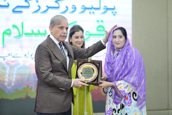 Prime Minister Muhammad Shehbaz Sharif presenting souvenirs to front line Polio Workers and the relatives of those Polio Workers who embraced martyrdom in the line of duty