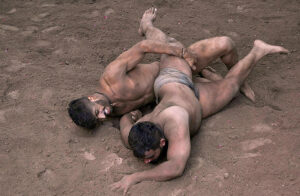 Traditional wrestlers (Pehalwans) are busy in practicing during a training session at an Akhara (wrestling pit).'Kushti', the traditional wrestling is one of the most popular games in Pakistan. Thousands of years ago when there was no cricket, no hockey, no football, the most enjoyable hobby of the people was wrestling. Even today after the introduction of so many kinds of sporting activities around the world, the sport of wrestling draws more crowds than any other sport because, fighting is a part of human nature. There are different styles of wrestling in the world today but the most famous among them is the Freestyle Wrestling