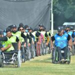 Players of Balochistan and Khyber Pakhtunkhwa Wheelchair Cricket teams meeting with each other after wheelchair cricket match during Interloop Quaid-e-Azam Wheelchair T-20 Cup 2024 at Bohran Wali Ground