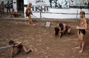 Traditional wrestlers (Pehalwans) are busy in practicing during a training session at an Akhara (wrestling pit).'Kushti', the traditional wrestling is one of the most popular games in Pakistan. Thousands of years ago when there was no cricket, no hockey, no football, the most enjoyable hobby of the people was wrestling. Even today after the introduction of so many kinds of sporting activities around the world, the sport of wrestling draws more crowds than any other sport because, fighting is a part of human nature. There are different styles of wrestling in the world today but the most famous among them is the Freestyle Wrestling