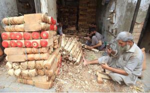 Carpenters making part of a traditional bed (charpai) at his workplace in Dabgari area.