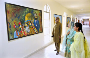 Art-loving visitors admiring paintings at the Sindh Museum.