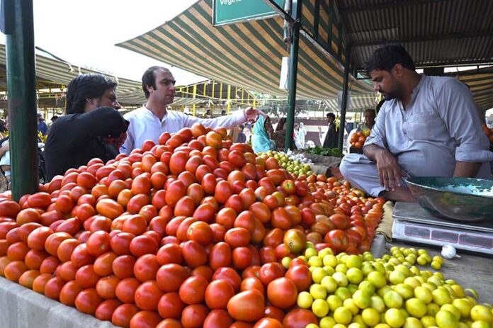 People purchasing vegetables at weekly bazaar Aabpara in the Federal Capital