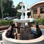 Laborers busy constructing a fountain at GPO Chowk