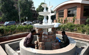 Laborers busy constructing a fountain at GPO Chowk