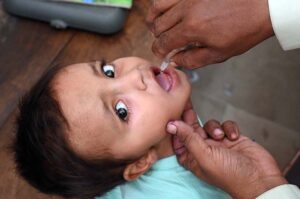 Health worker administering polio drop to a child during an anti-polio campaign 28th October to 3rd November at Bhitai Hospital