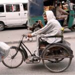 A disabled elder seeks compassion while sitting on a wheelchair from passersby at Chowk Yadgar