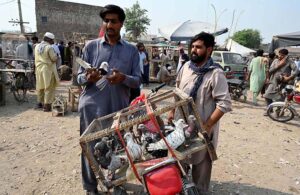 Customers selecting and purchasing pigeons from Jumma bazar Ring road.