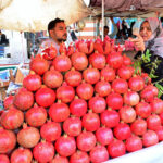 A Woman Selects and Purchases Pomegranates from a Vendor at Fakir Ka Pir Road