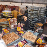Workers busy packing traditional food items to delivery to different bakeries at biscuits factory, SITE area