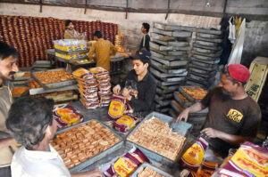 Workers busy packing traditional food items to delivery to different bakeries at biscuits factory, SITE area