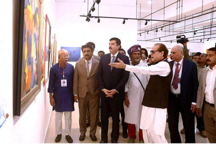 Governor of Khyber-Pakhtoonkhwa Faisal Kareem Kundi, alongside Sindh Minister for Culture and Tourism Zulfikar Shah, views paintings after inaugurating the 'Sindh Artists Exhibition' at the World Culture Festival, held at the Arts Council of Pakistan