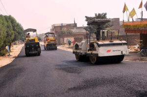 Laborers are carpeting the Lodhi colony road during the city development work