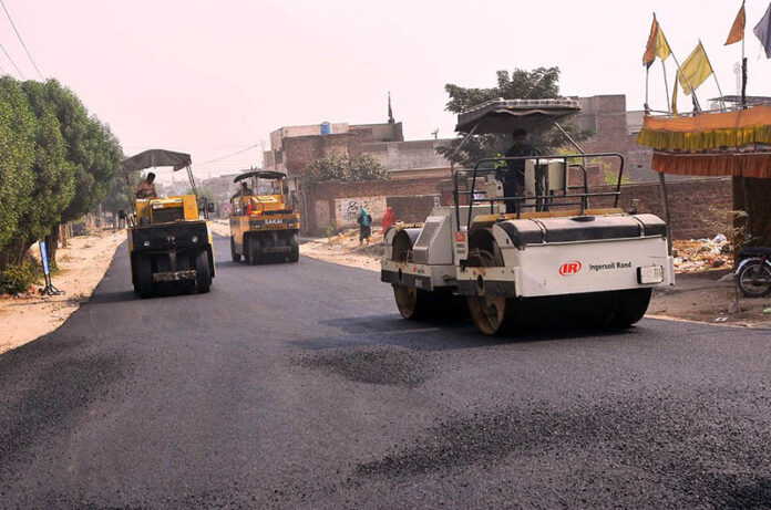 Laborers are carpeting the Lodhi colony road during the city development work