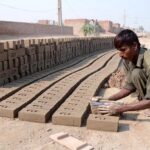 A laborer making raw bricks at a local kiln, showcasing the hard work behind construction