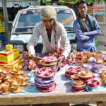 A vendor displaying the earthen lamps to attract the customers in connection with Diwali Festival