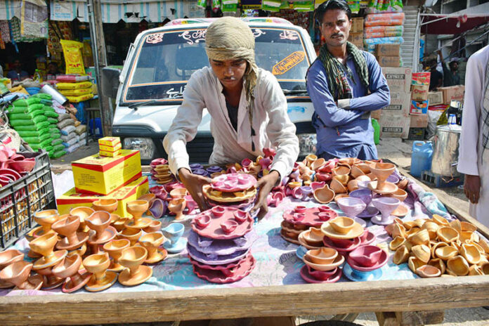 A vendor displaying the earthen lamps to attract the customers in connection with Diwali Festival