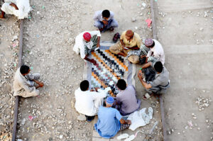 People playing cards to spend their leisure time on railway tracks near Railway Station.