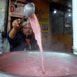 A shopkeeper prepares traditional Kashmiri tea, a beloved winter season treat, to attract passerby at Abpara Market in federal capital