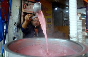 A shopkeeper prepares traditional Kashmiri tea, a beloved winter season treat, to attract passerby at Abpara Market in federal capital