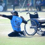 A fielder falls while attempting to catch the ball during the wheelchair cricket match between Balochistan and Sindh teams at the Interloop Quaid-e-Azam T-20 Cup Wheelchair Cricket 2024 at Bohran Wali Ground