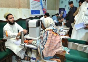 Doctors examining patients during free eye camp organized by Peshawar Press Club for journalists' families at Press Club.