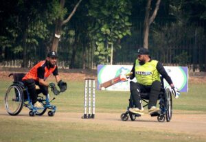 Players in action during the wheelchair cricket match between Sindh and Khyber Pakhtunkhwa teams for the Interloop Quaid-e-Azam T-20 Cup Wheelchair Cricket 2024 at Bohran Wali Ground