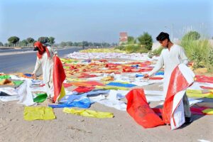 Labourers are busy spreading plastic bags for drying purpose after washing at the roadside