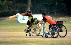 Players in action during the wheelchair cricket match between Sindh and Khyber Pakhtunkhwa teams for the Interloop Quaid-e-Azam T-20 Cup Wheelchair Cricket 2024 at Bohran Wali Ground