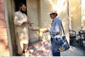 A postman is collecting letters from a post box at GPO Cantt for further delivery as world celebrates World Post Day on 9th October.
