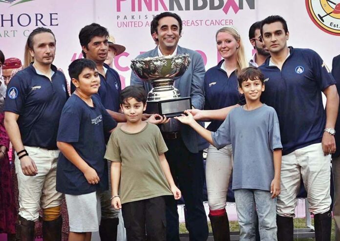 Chairman PPP Bilal Bhutto Zardari presenting the trophy to the successful team of polo match at Polo Ground