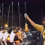 A vendor preparing Saji outside his restaurant in the city