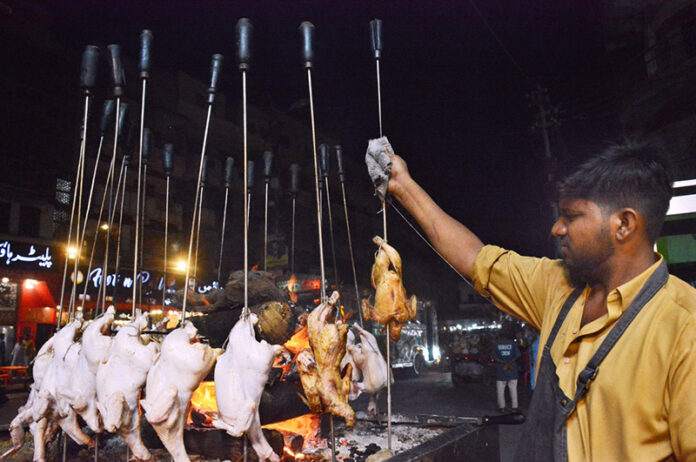 A vendor preparing Saji outside his restaurant in the city
