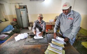 A postman is collecting letters from a post box at GPO Cantt for further delivery as world celebrates World Post Day on 9th October.