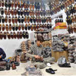 Cobblers making and package traditional Peshawari chappals by hand at their workshop, preserving the art of handmade footwear