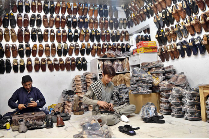 Cobblers making and package traditional Peshawari chappals by hand at their workshop, preserving the art of handmade footwear