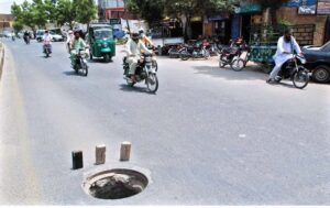 Open manhole of sewerage system on main roads of the city posing threat to pedestrians and routine traffic.