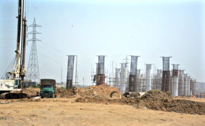 Labourers busy in construction work of flyover at Korangi River during development work in Provincial Capital.