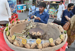 A vendor displaying roasted sweet potatoes (Shakarkandi) to attract the customers on roadside in the City