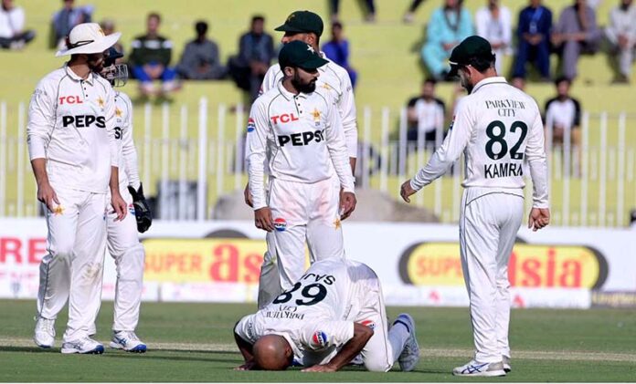 Pakistan's Sajid Khan bows his head in gratitude to Allah at Pindi Cricket Stadium, celebrating his fifth wicket on day one of the third Test match against England