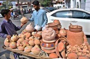 A young vendor display and sells pottery to attract customers at Abbott Road.