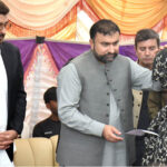 Chief Minister Balochistan Sarfraz Bugti is giving cheques to the family members of laborers killed in terrorist attack in Balochistan at Shuja Abad
