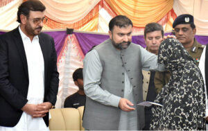 Chief Minister Balochistan Sarfraz Bugti is giving cheques to the family members of laborers killed in terrorist attack in Balochistan at Shuja Abad